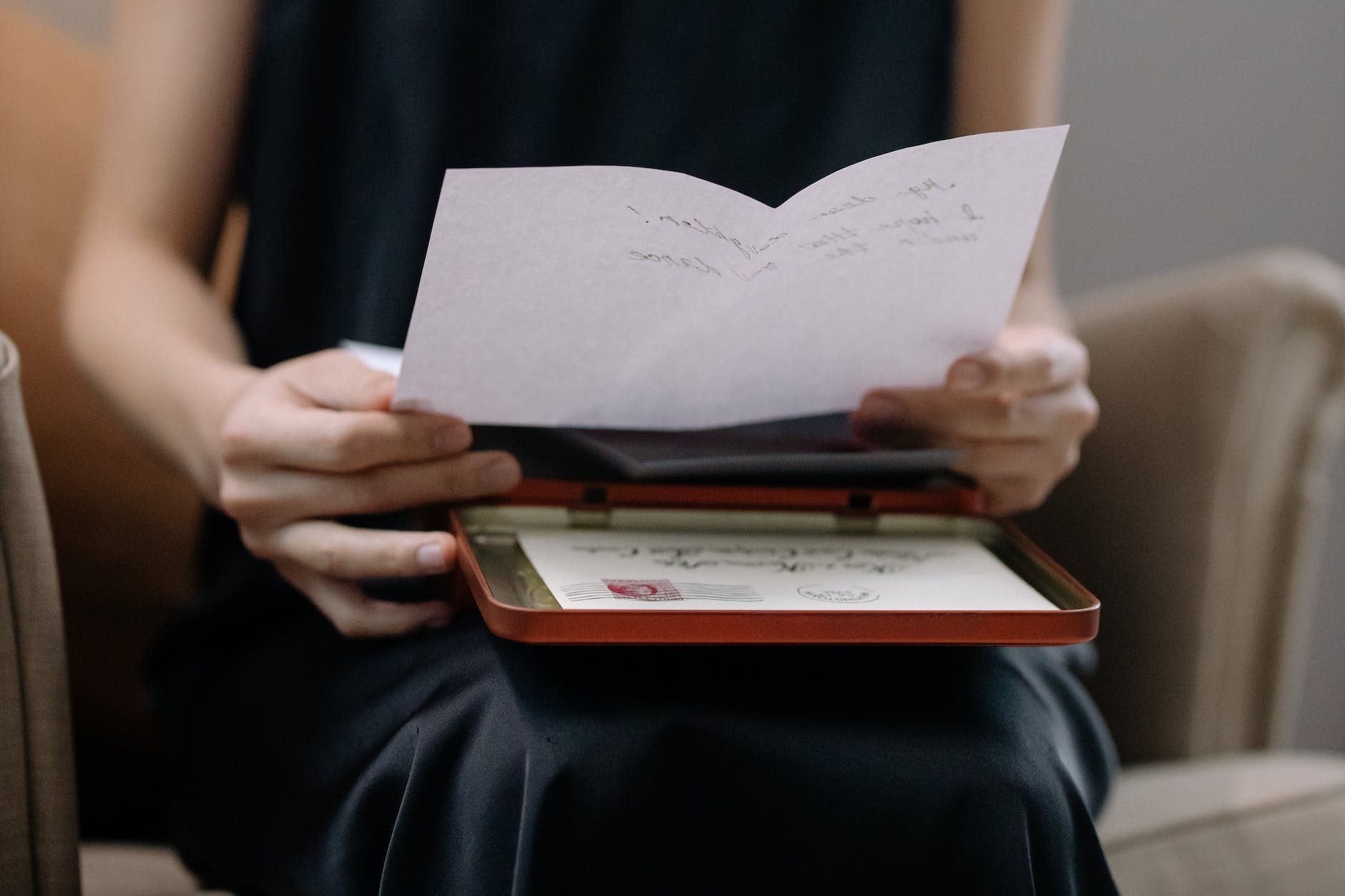 a person holding white paper